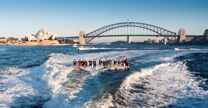 Riviera 61 series II Enclosed Flybridge luxury motor yacht and elite water skiers in Sydney Harbour