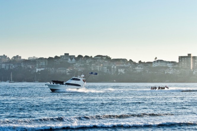 Riviera 61 series II Enclosed Flybridge luxury motor yacht and waterskiers in Sydney Harbour
