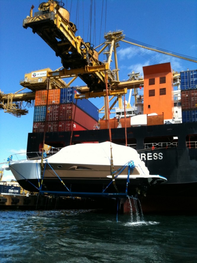 A new 5000 Sport Yacht is loaded onto a ship destined for an international port