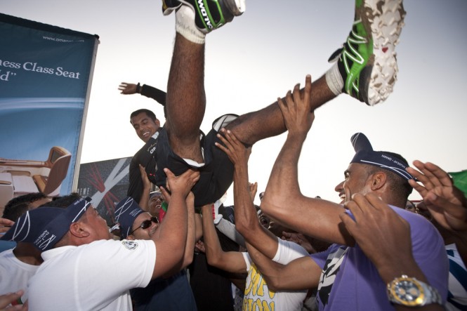 Local hero Nasser Al Mashari, the bowman on board winning team Oman Air, crowd surfs after the prizegiving Credit Lloyd Images