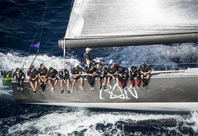 Crew of Ran 2 yacht sitting on the rail - Photo by Rolex Kurt Arrigo