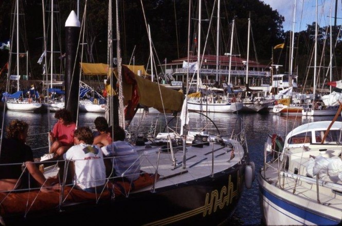 The fleet at rest: The crew of Joe Goddard’s Inch by Winch – one of the 93 yachts at the inaugural Hamilton Island Race Week in 1984 – relax on the foredeck post-race inside Hamilton Island’s harbour. (Image: Sandy Peacock)