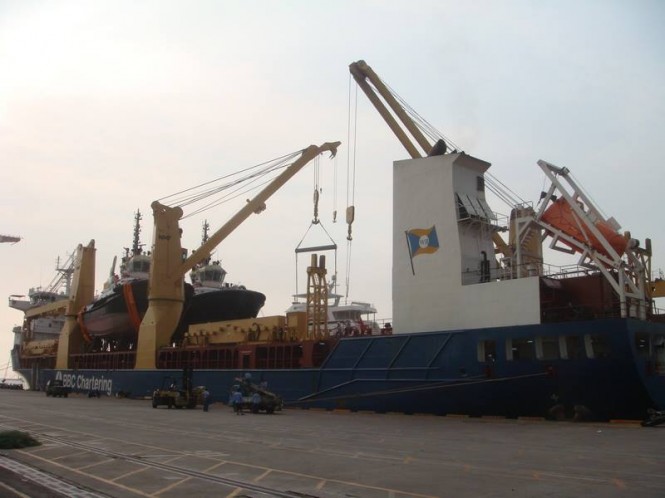 Luxury yacht Outer Reef 700 loaded on a ship to be delivered to Ft. Lauderdale