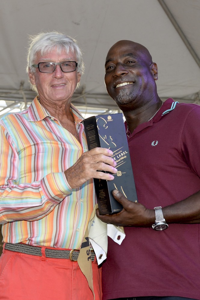 Two veteran sporting icons from Antigua: Sir Viv Richards presents Biwi Magic owner, Geoffrey Pidduck with  Johnnie Walker prizes for first place on the Johnnie Walker Race Day 2 at Antigua Sailing Week - Credit: Ted Martin/Photofantasyantigua.com