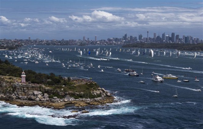 Bird's eye view of start of the 2012 Rolex Sydney Hobart, with cityscape in background - Photo by Rolex Carlo Borlenghi