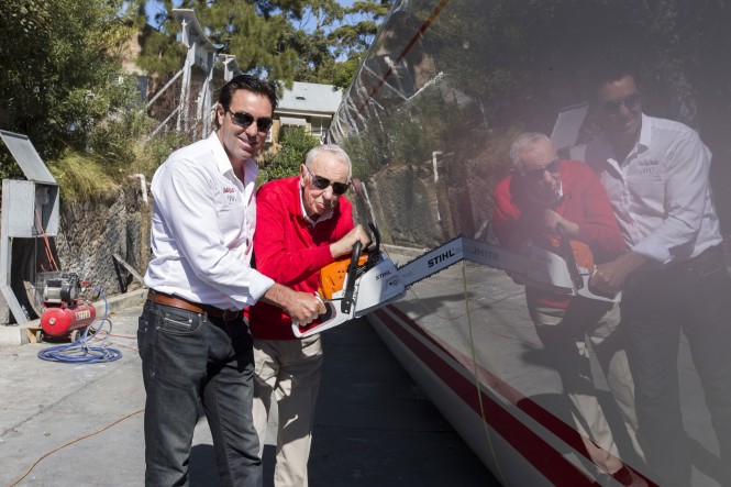 Bob Oatley and Mark Richards make the first cut into the forward sections of the all-conquering supermaxi yacht Wild Oats XI. (Image credit to Andrea Francolini)