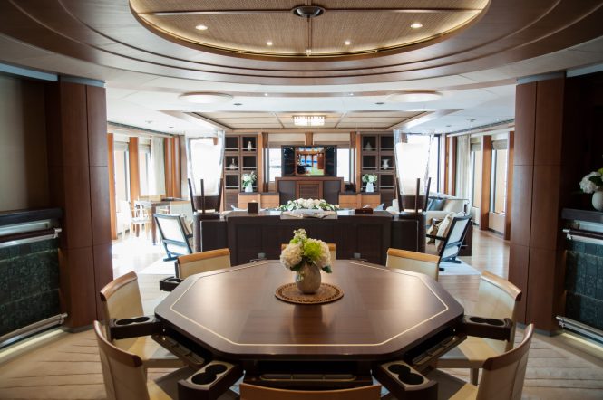 Oceanco yacht Anastasia at MYS 2017 - upper deck saloon with games : dining table and seating area