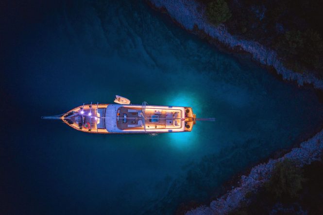 Aerial view of the yacht in a bay in Croatia by night