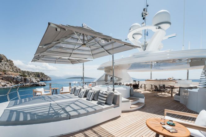 Spacious sun deck with Jacuzzi, sunbathing and dining areas