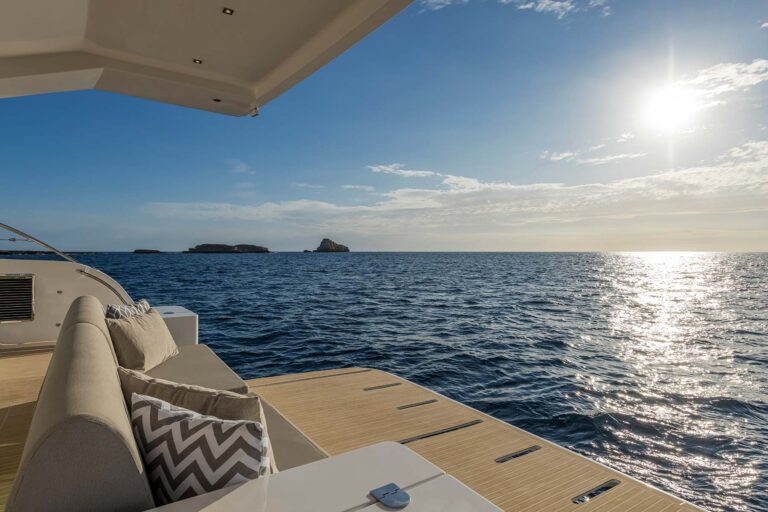 Aft facing sofa over central swim platform