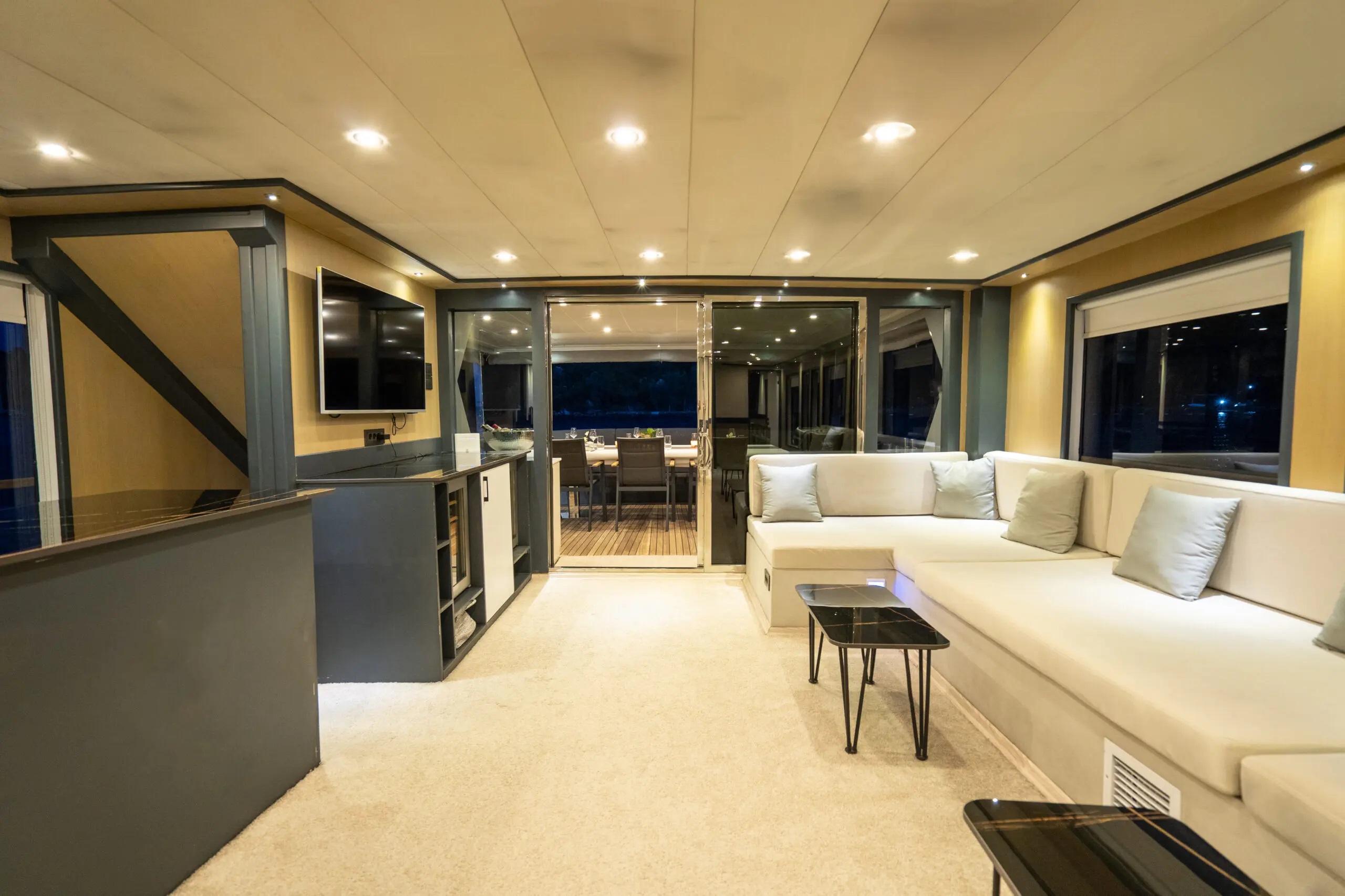 304 Main salon at night view to aft deck.jpg