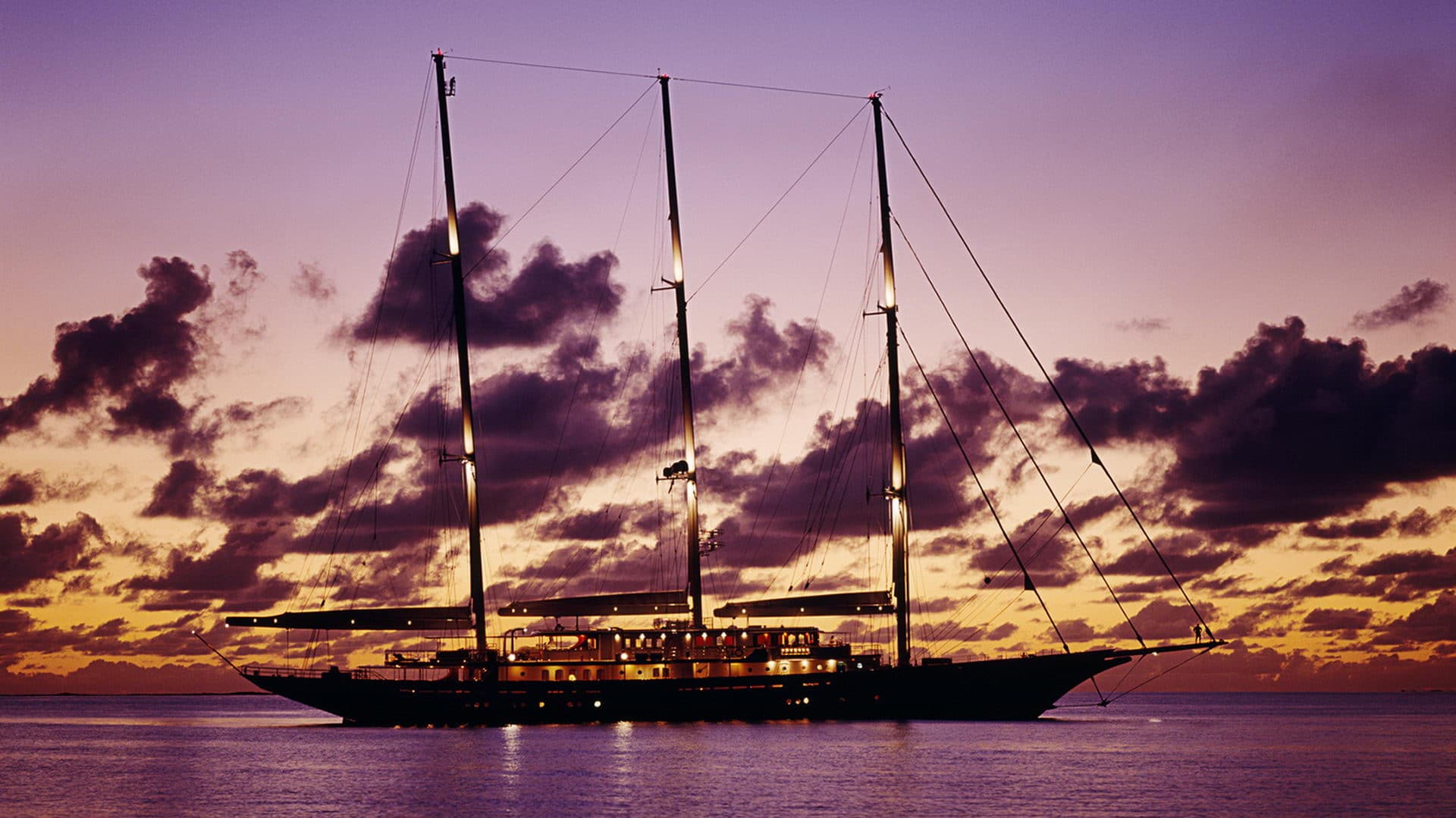 90m Royal Huisman 3-masted schooner at sunset.jpg