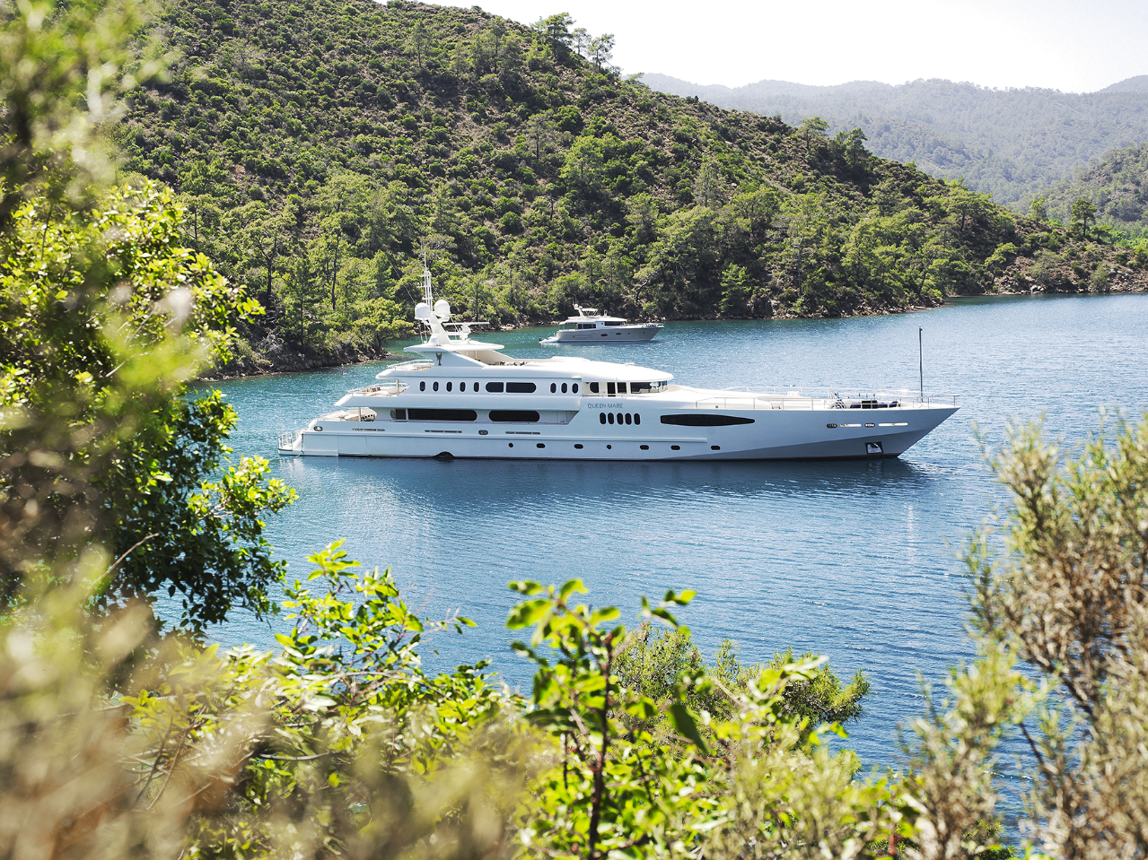 Queen Mare yacht in a bay.png