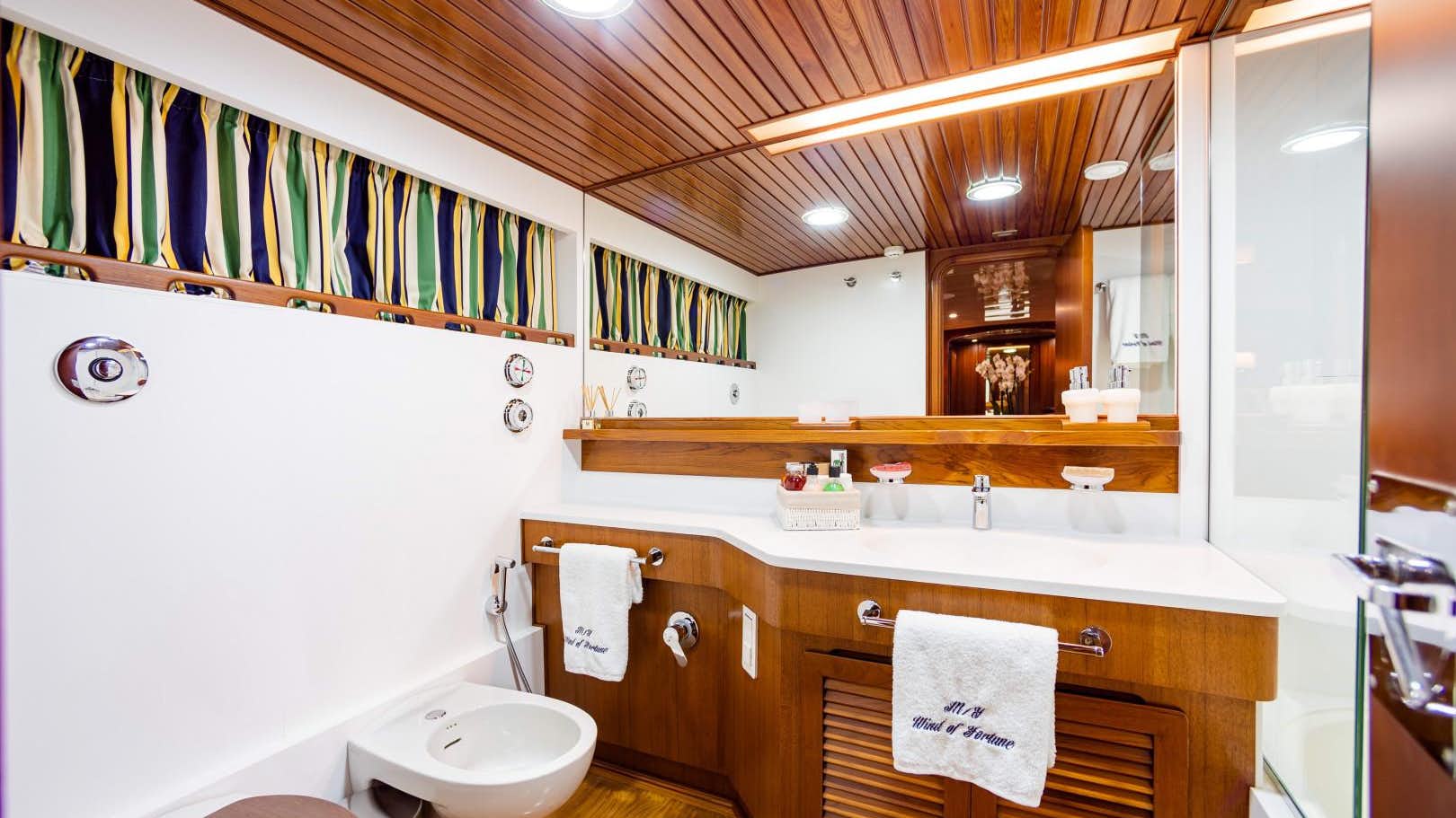 a bathroom with a toilet and a sink aboard.jpg