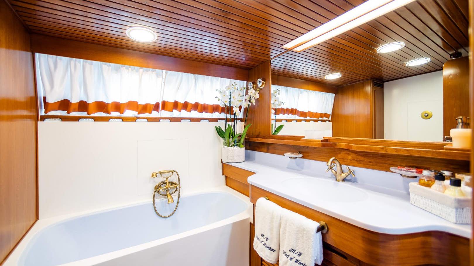 a bathroom with a tub sink and cabinets aboa (1).jpg