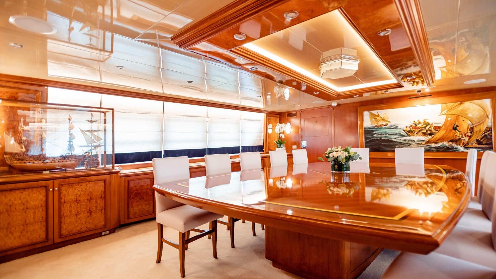 a large room with a table and chairs aboard_.jpg