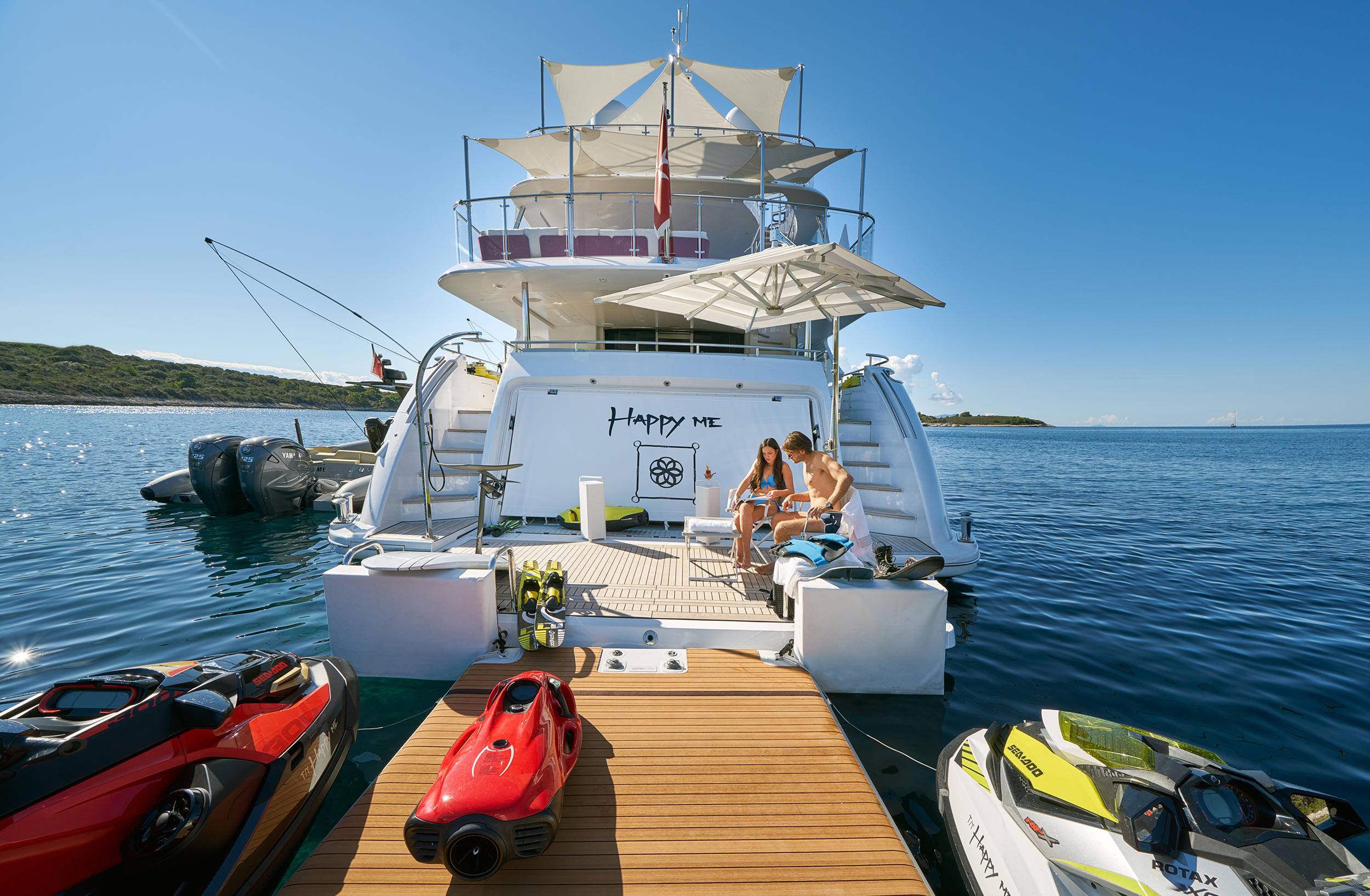 couple on the yacht's swim platform and toys.jpg