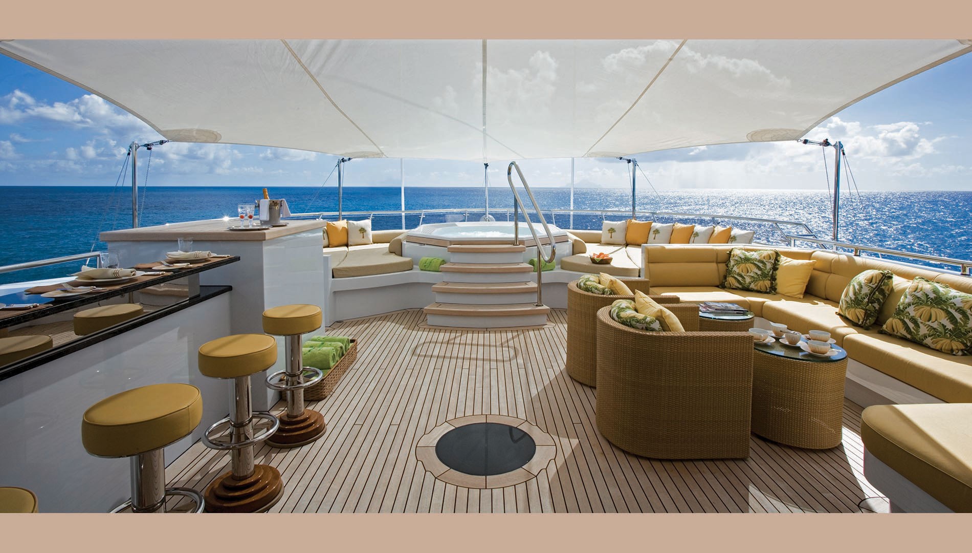expansive sun deck with Jacuzzi, bar and seating areas.jpg