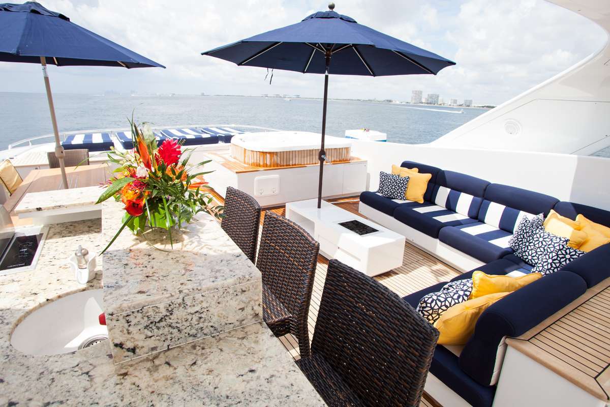 Sun deck Jacuzzi and seating area with a bar.jpg
