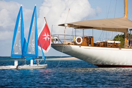 Tiziana at anchor and sailing dinghies.jpg