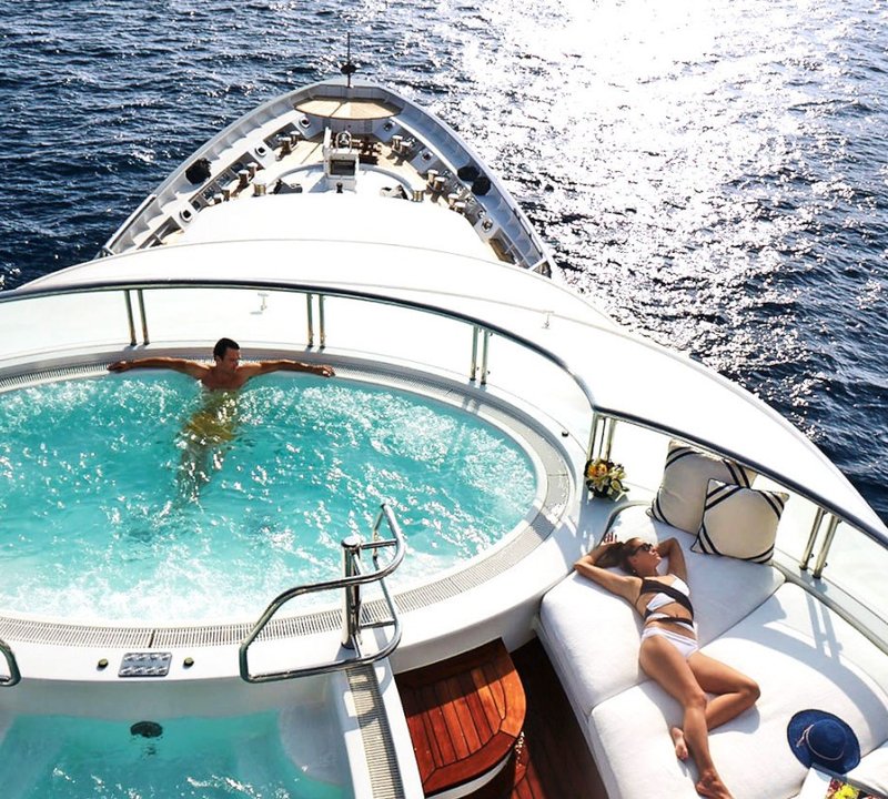 Sundeck And Jacuzzi Pool With Sunbathers